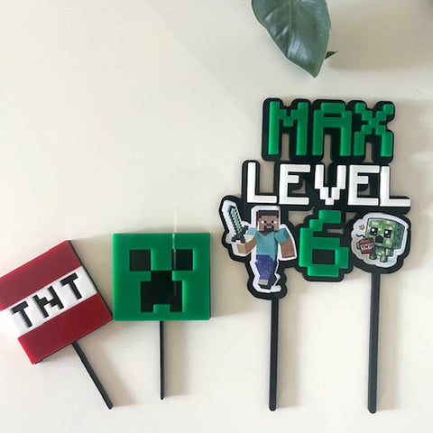 Minecraft-themed birthday cake toppers on a white background