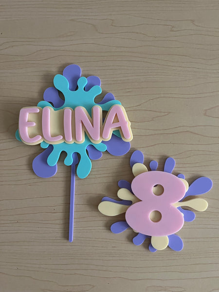 Colorful decorative letters spelling 'ELINA' on a wooden surface