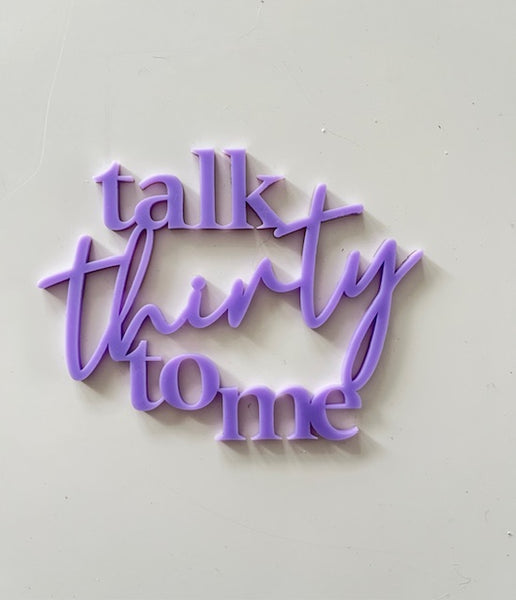 Purple decorative sign with 'talk thirty to me' text on a light gray background