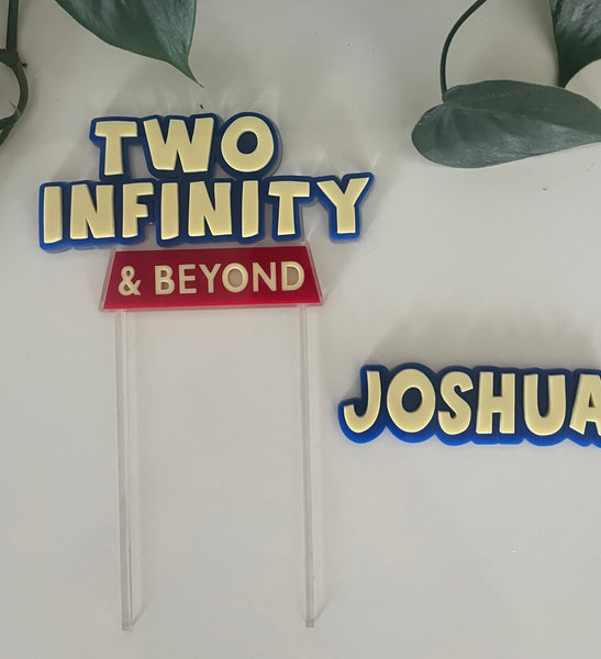 Decorative name and phrase signs on a white wall with green leaves.