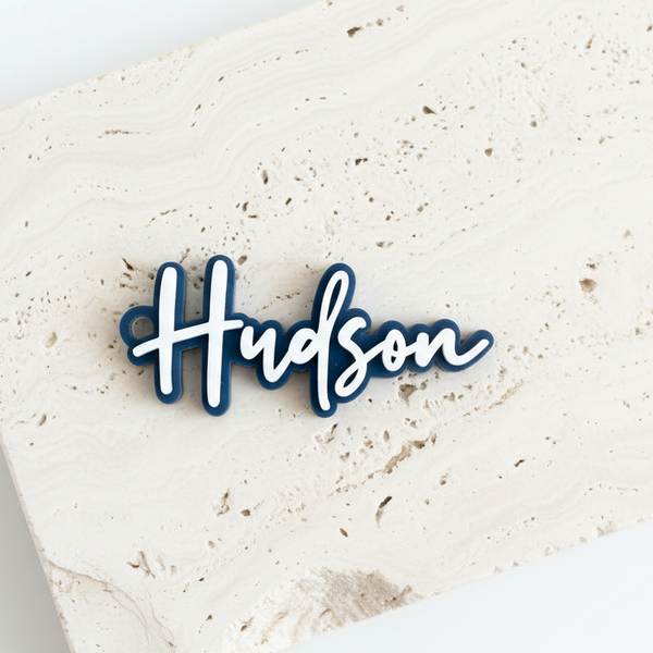 Hudson Dark Blue Bag Tag Flat on Travertine