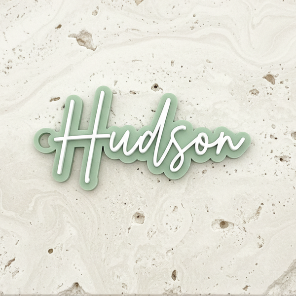 Hudson Sage Green Bag Tag Flat on Travertine