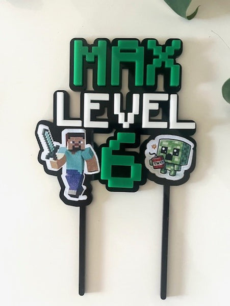 Cake topper with 'Max Level 6' text and Minecraft-themed characters on a white background
